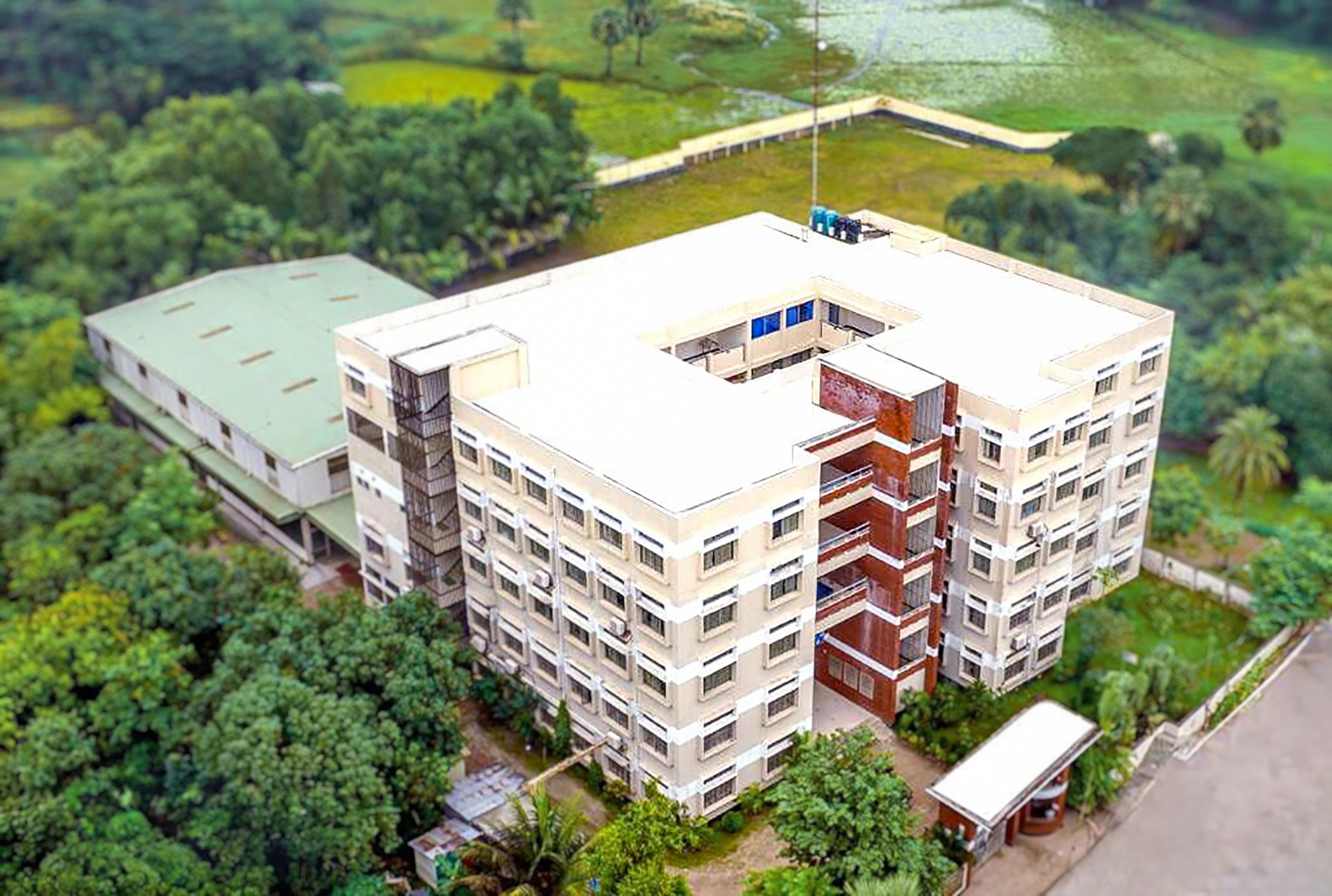 The NDMSC school building surrounded by campus greenery